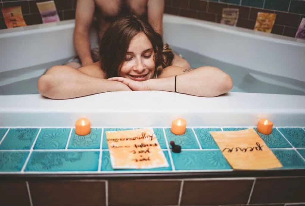Hypno-mom in birth tub with partner behind her and she is smiling